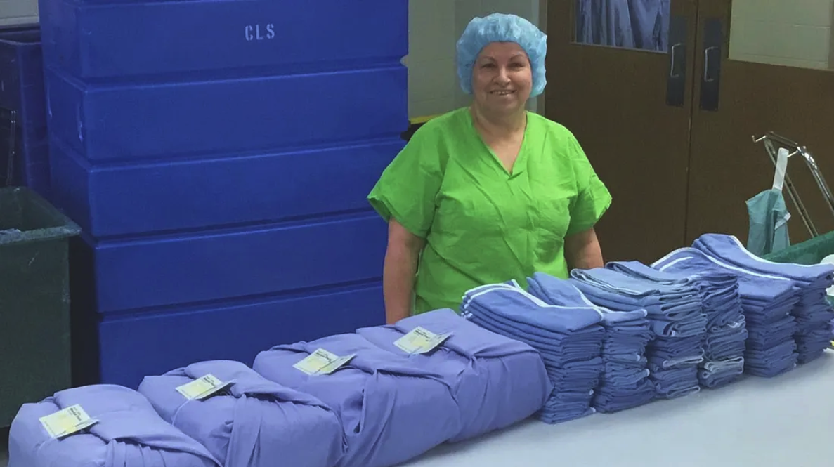 Reusable gowns displayed by health care worker